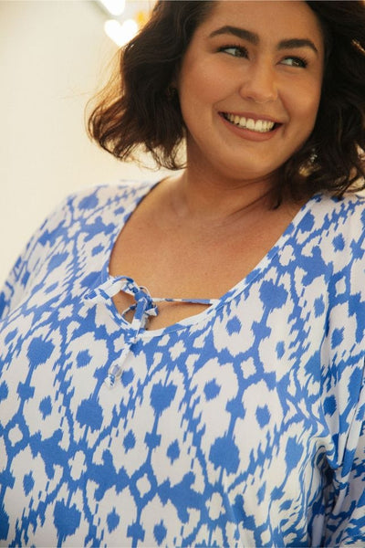 close up photo of model in the blue and white kaftan showing the tie detail at the front