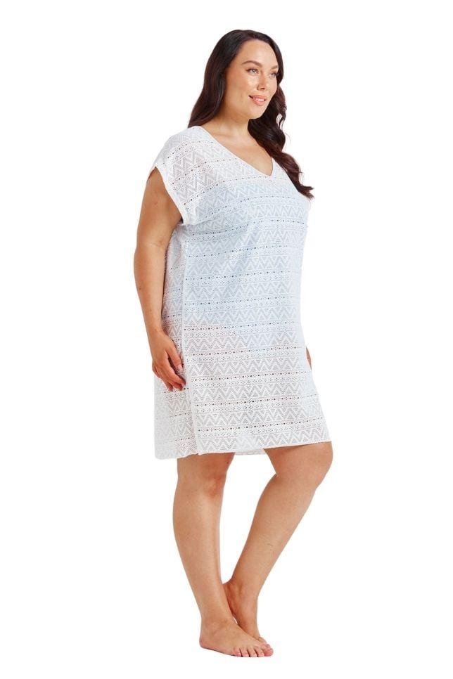 Brunette model showing side of white mesh cover up