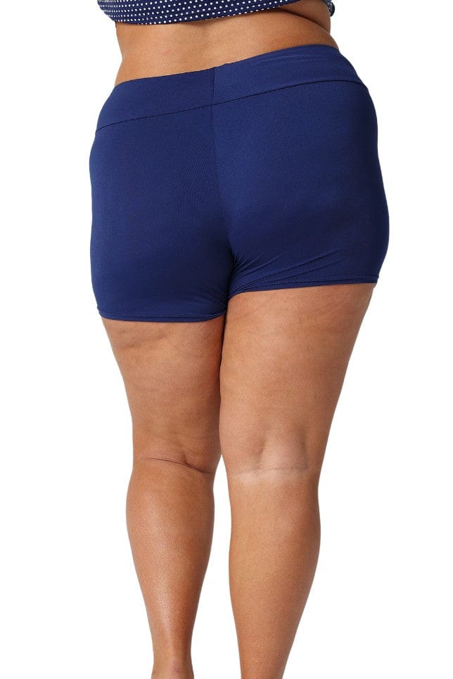 Back of plus size model wearing high waisted navy boy leg swim shorts
