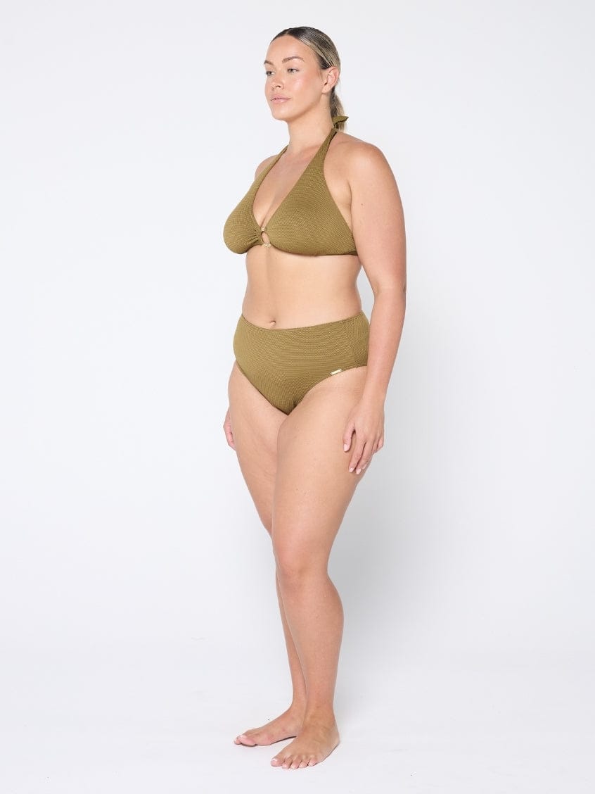 Woman wearing a green bikini set on a white background