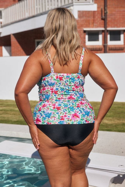 Back of curvy model wearing flattering underwire tankini top with ruching in bright colours