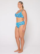 Woman wearing a blue patterned bikini set on a white background