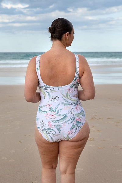 plus size woman wearing white tropical high neck mesh jantzen swimsuit scoop low back