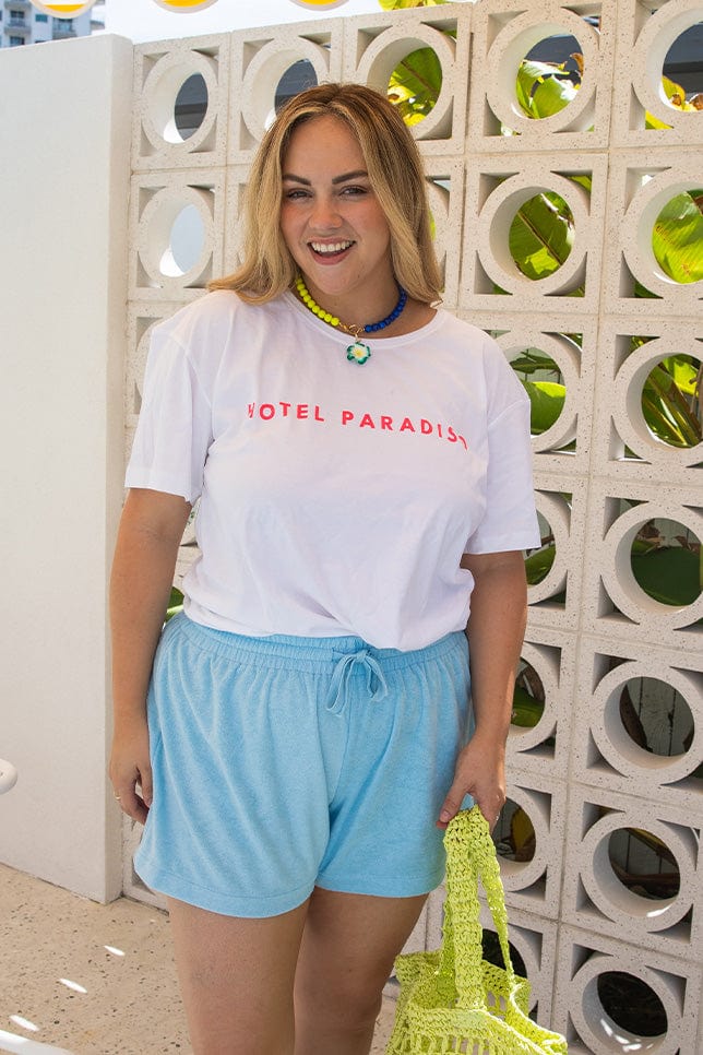 Blonde women wearing plus size loose white t shirt with pink writing