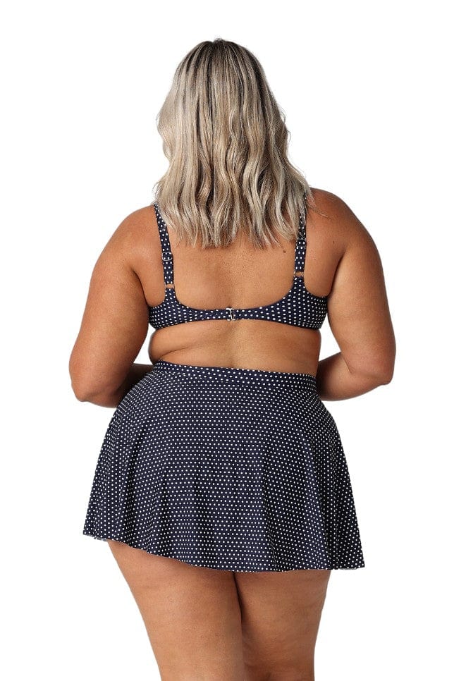 Back of model in studio wearing navy and white high waisted skirt