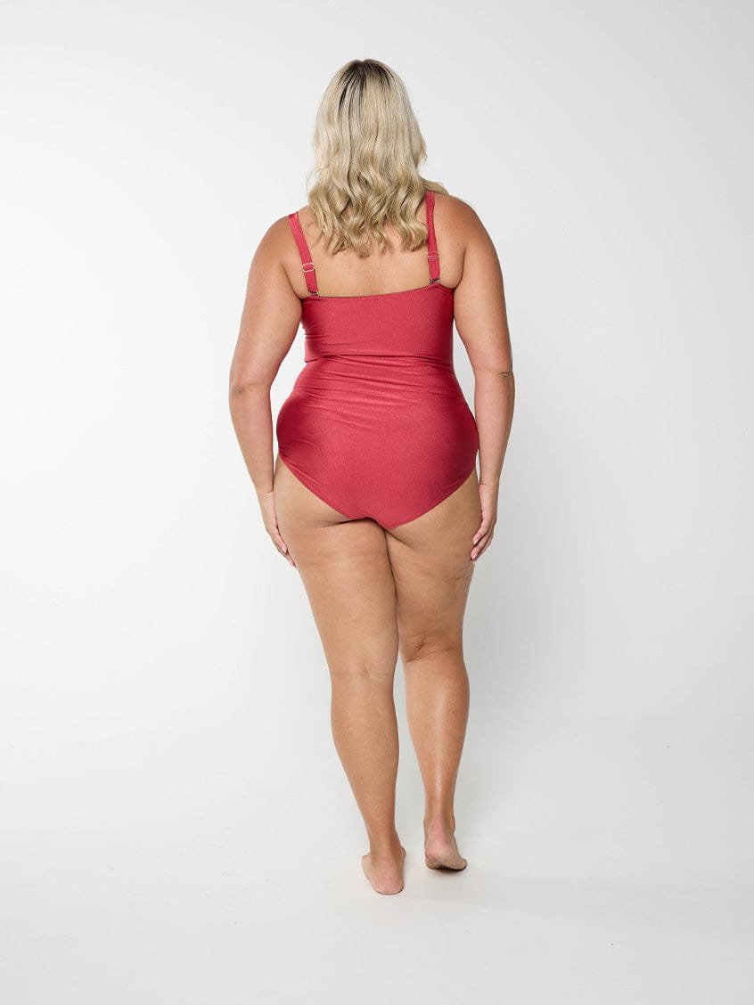 Back of curvy model wearing a strapless bandeau one piece