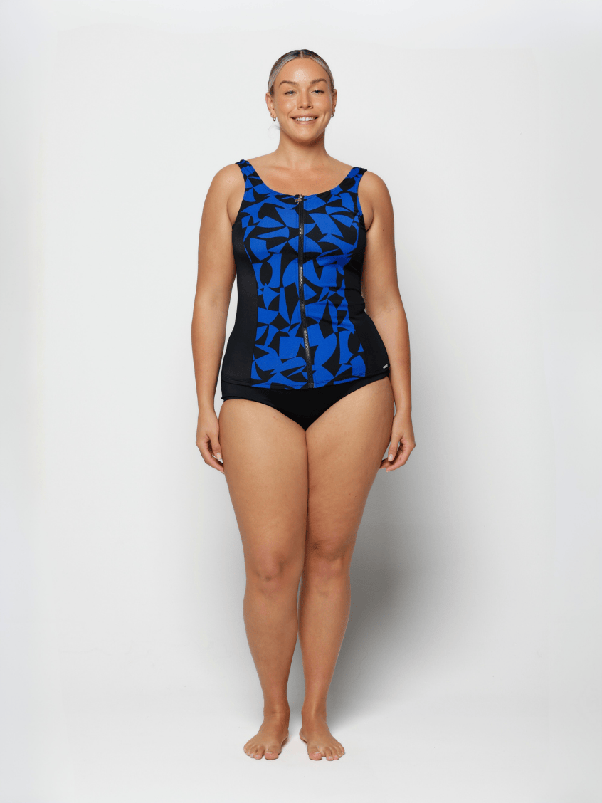 Woman wearing a black and blue patterned swimsuit on a white background