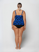Woman wearing a blue and black patterned tankini on a white background