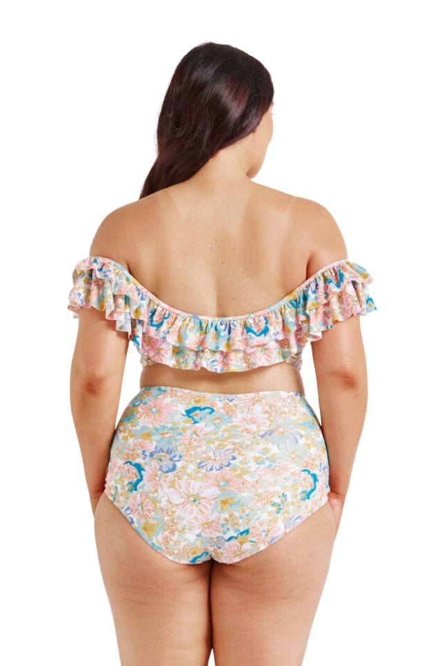 Brunette model wearing curve floral bikini top in pastel colours with ruffle frill detail