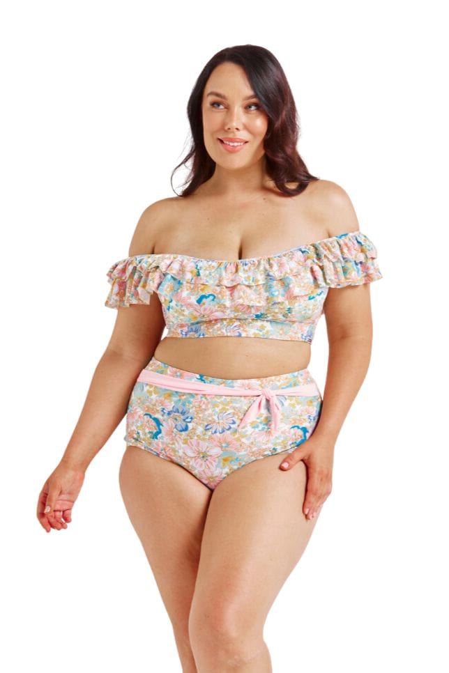 Brunette model wearing pastel floral bikini top with ruffle detail