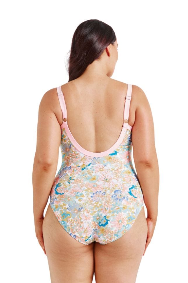 Brunette plus size model wearing  scoop back one piece with adjustable straps in floral print