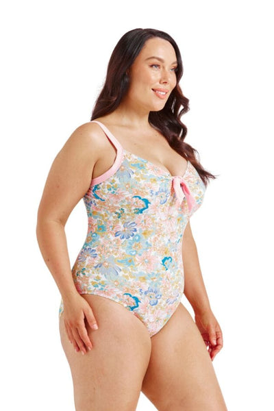 Model wearing plus size one piece with tie front detail and pastel colours