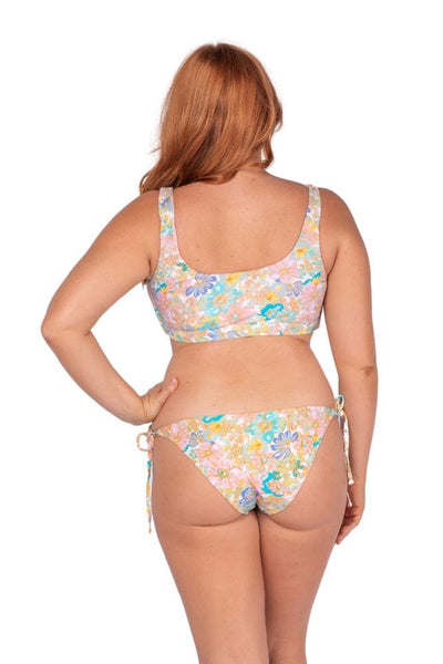 Back of women wearing flattering low rise bikini bottoms with tie side detail