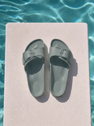 Sage birkenstock by pool with one strap