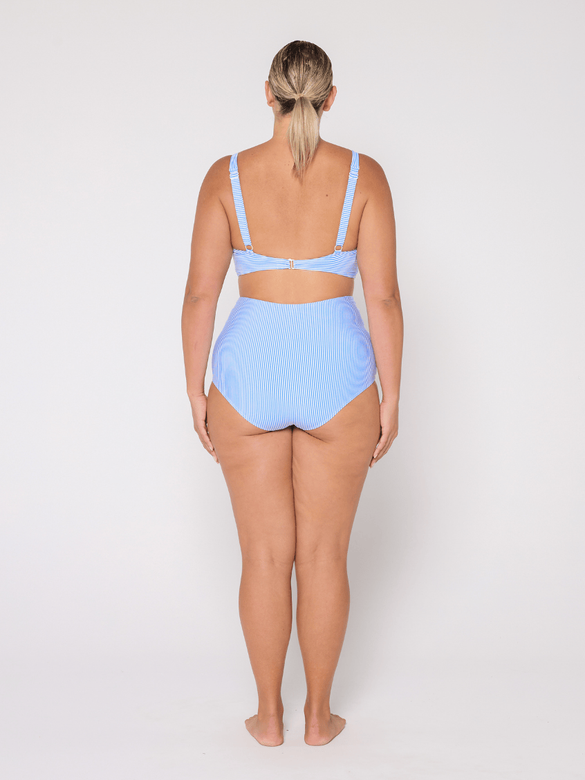 Woman wearing a light blue bikini set on a white background