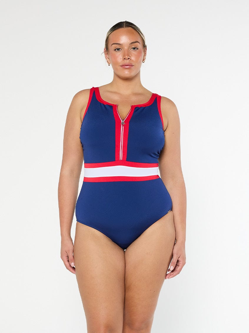 Woman wearing a blue and red swimsuit with a white stripe on a white background