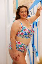 Brunette curve model wearing floral high waisted pant