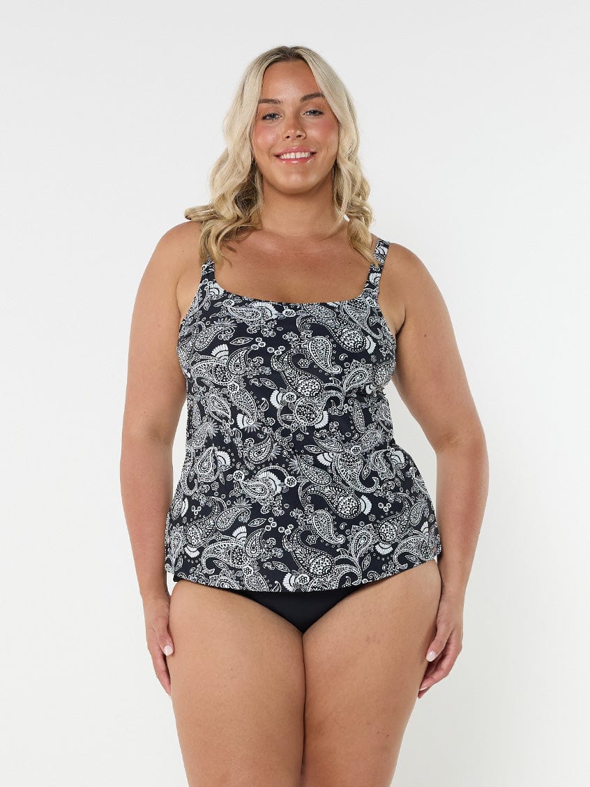 Blonde woman in studio wearing tank tankini top in black and white paisley print