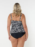 Blonde woman in studio wearing plus size tank tankini top with adjustable straps in black and white paisley print