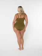 Person wearing a green swimsuit on a white background
