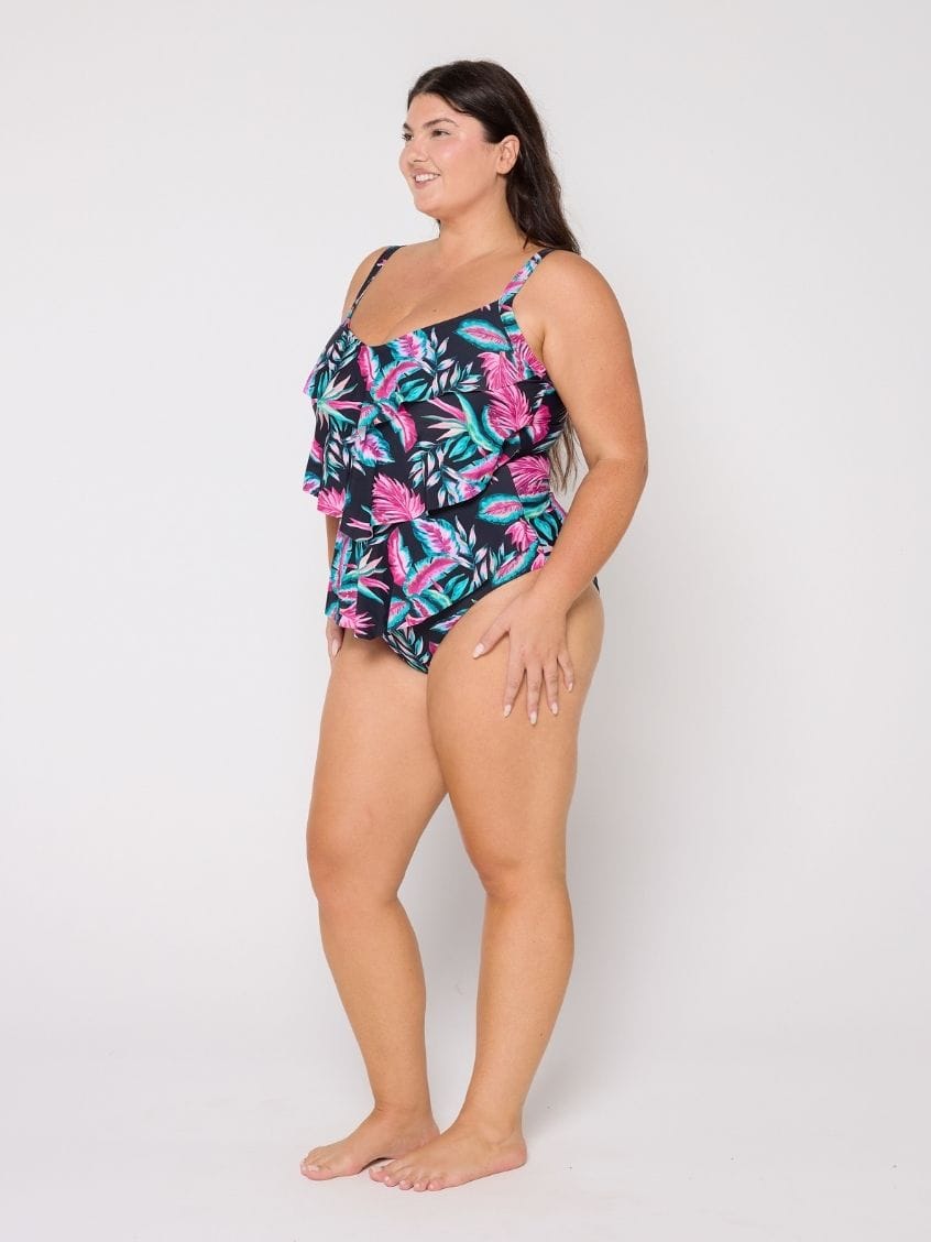 Woman wearing a floral swimsuit on a white background
