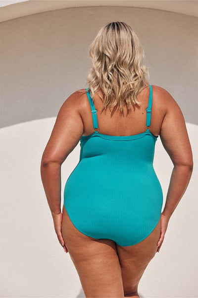 plus size blonde model wears aqua blue one piece with full coverage bottom