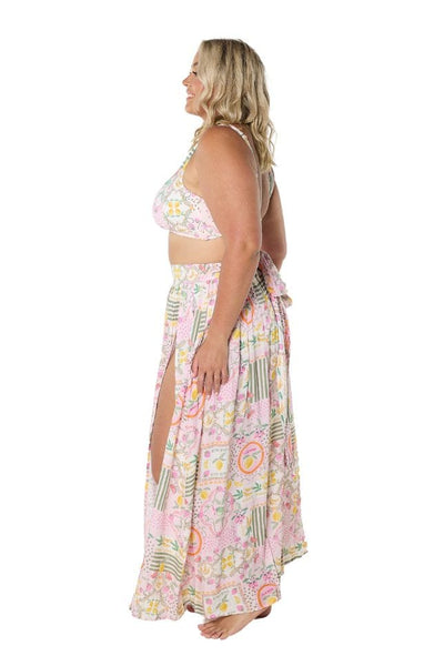 Side profile of model wearing long flattering skirt with high slit for curve women
