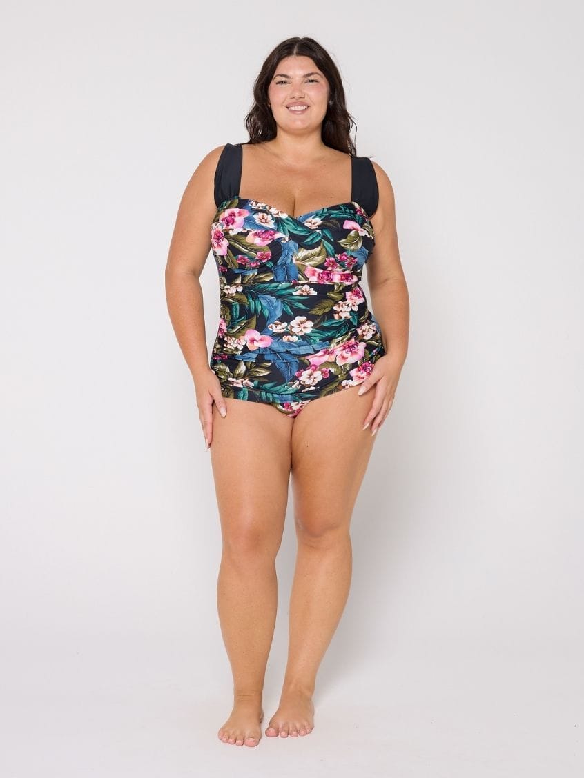 Woman wearing a retro style floral swimsuit on a white background