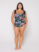 Woman wearing a retro style floral swimsuit on a white background