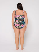 Woman wearing a floral swimsuit on a white background