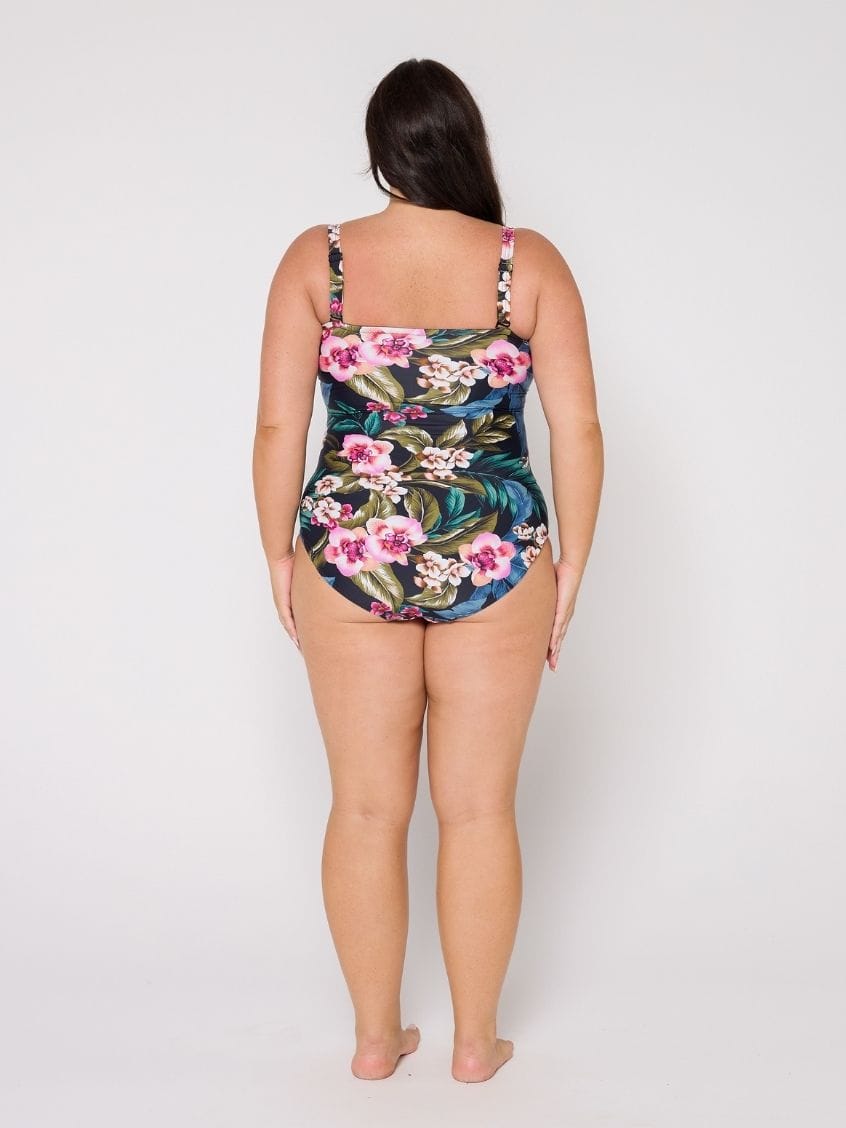 Woman wearing a floral swimsuit on a white background