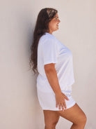 Side profile of model wearing a terry towelling white t shirt for curve women