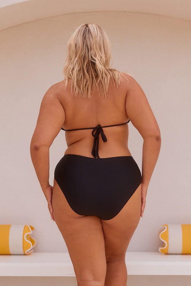 Blond model showing back of black high rise bikini bottoms