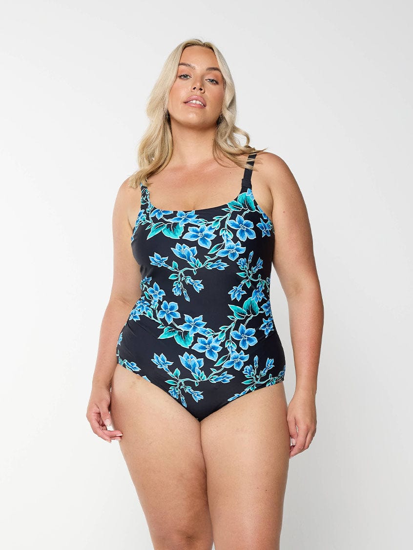 Blonde women shows plus size one piece swimsuit with blue floral design