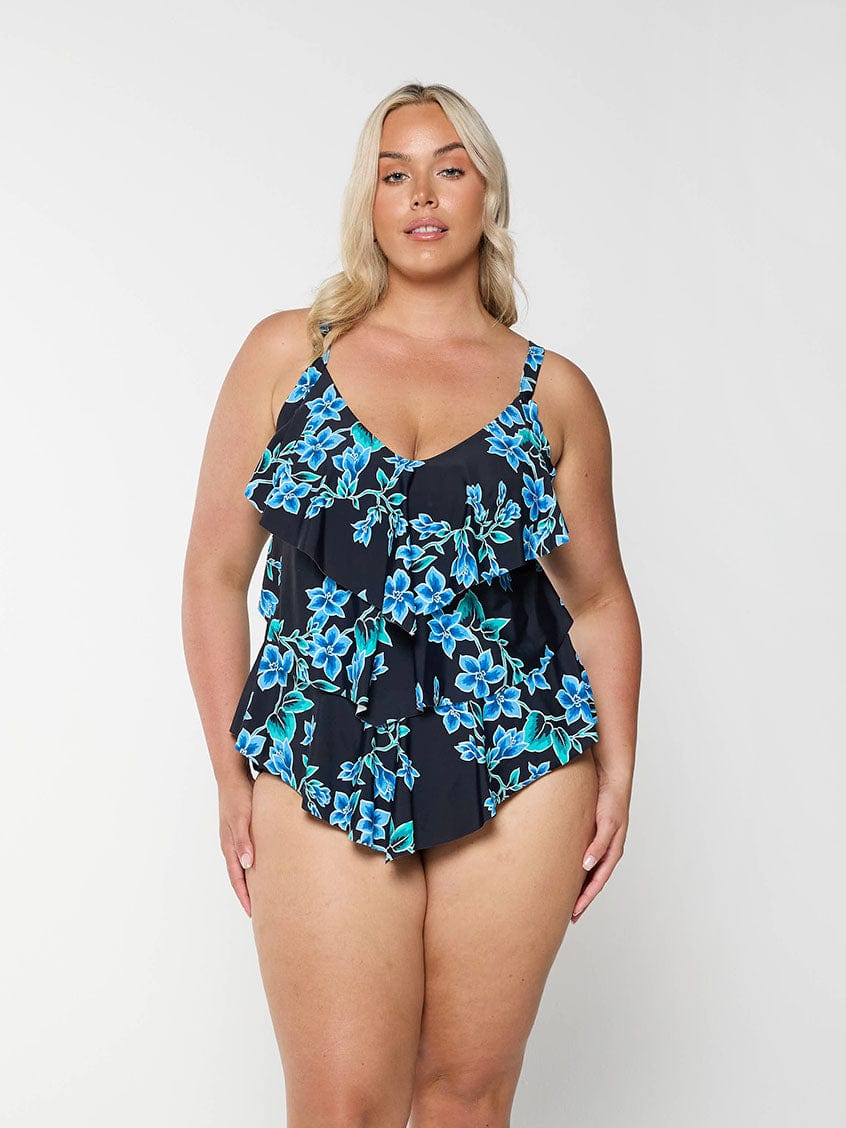 Blonde model shows front of blue floral tankini top with 3 tier ruffles