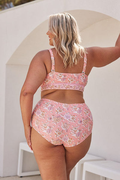 Blonde model showing back of pink floral bikini top and matching high waisted pant