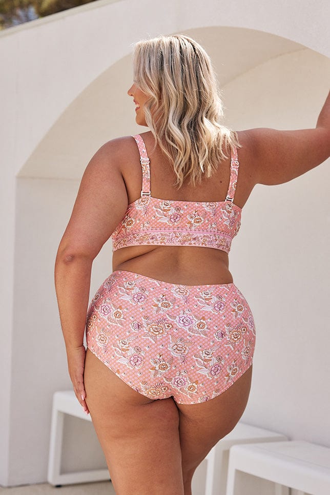 Blonde model showing back of pink floral bikini top and matching high waisted pant