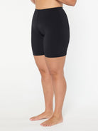 Person wearing black shorts on a white background