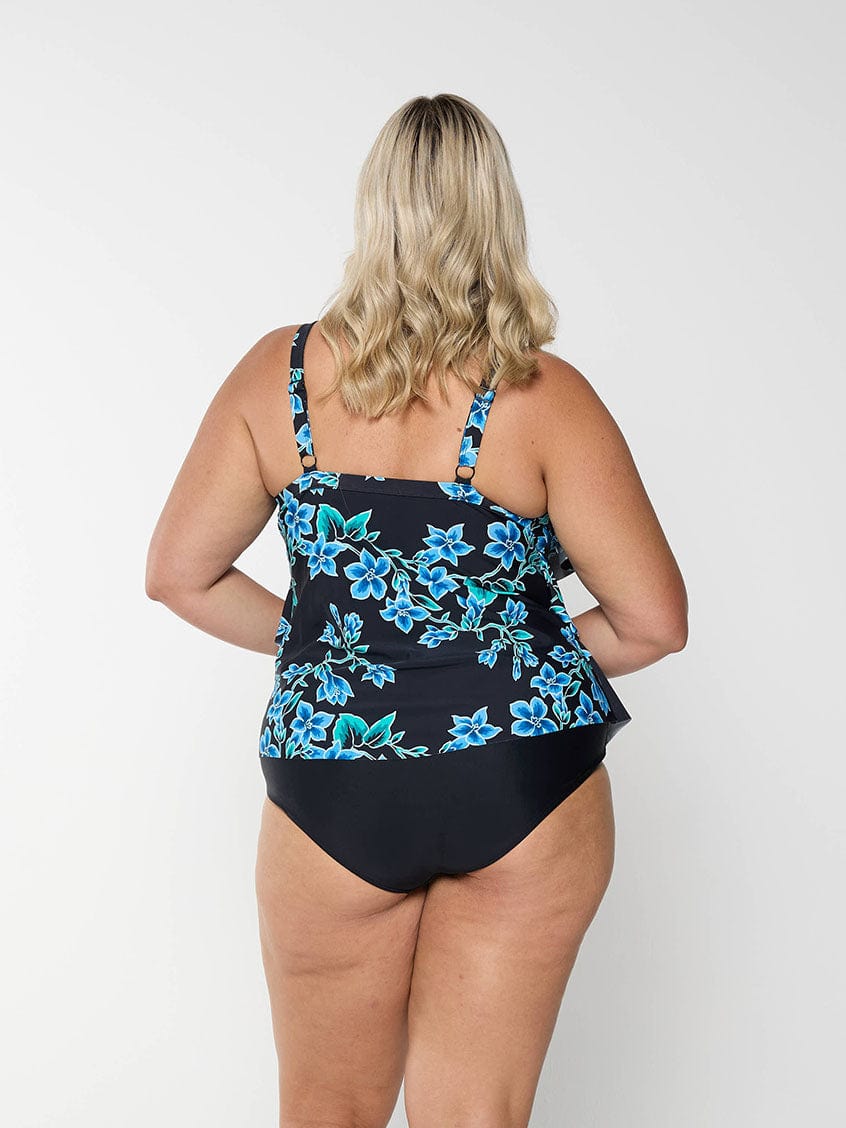 Model shows back of blue floral tankini top with adjustable straps
