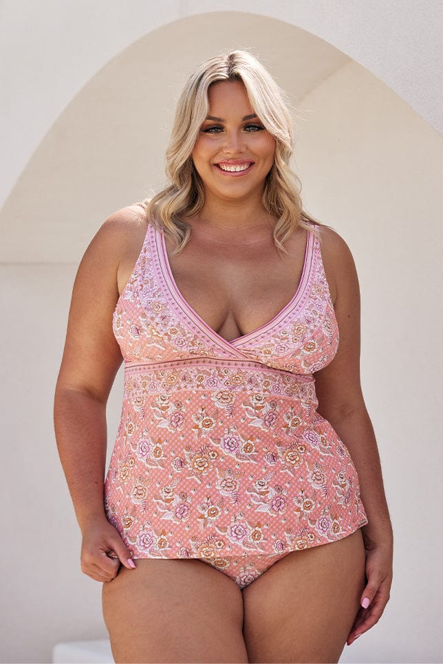 Blonde model wearing pink floral v neck tankini top