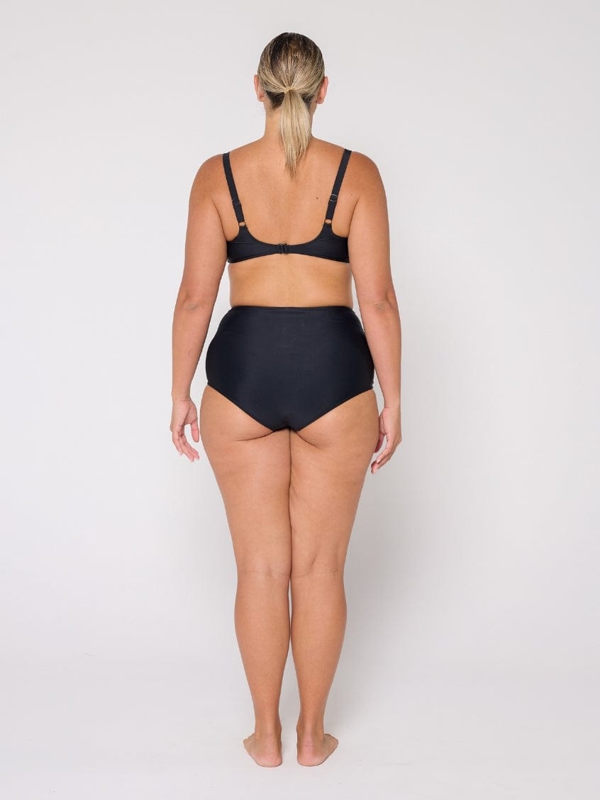 Person wearing a black bikini set on a white background