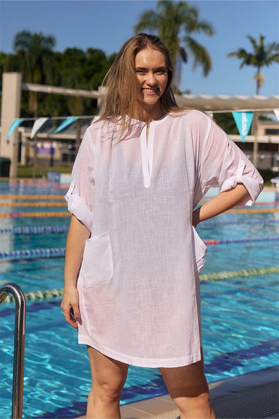 Blonde model wearing white overshirt at pool