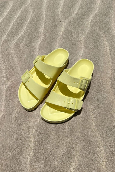 Women's light yellow slide on sandal on beach