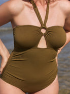 Green swimsuit worn by a person with a blurred background