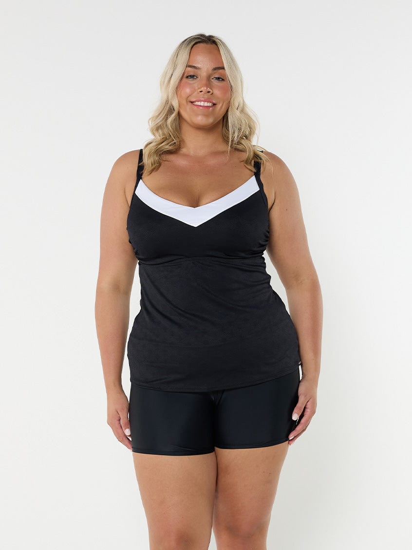 Blonde model showing side of black and white underwire tankini
