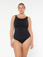 model wearing black high neck one piece