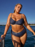 model wearing navy polka dot bikini set on boat