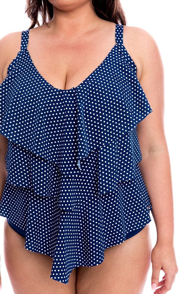 Close up of model wearing navy and white dots tankini