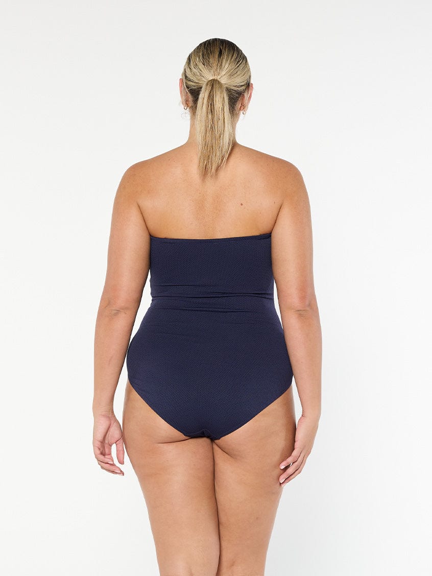 model showing back of textured navy bandeau one piece
