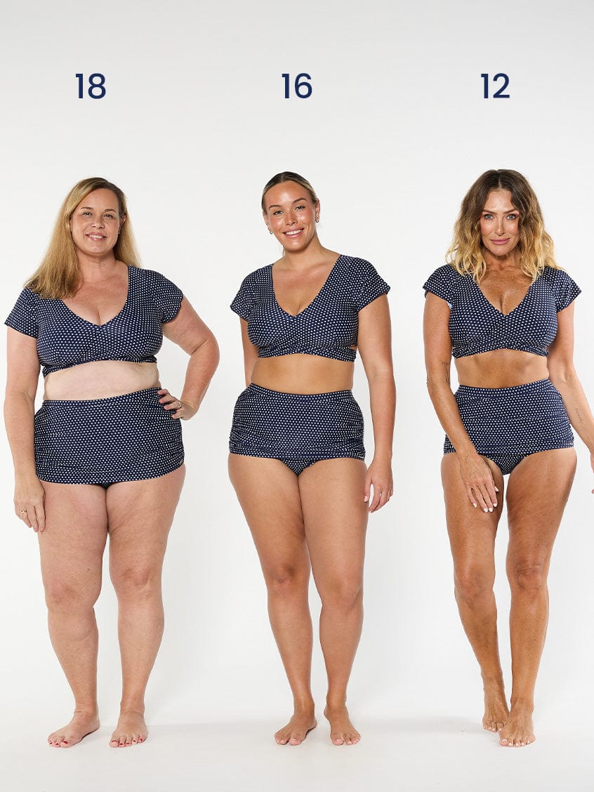 three models wearing navy polka dot wrap top with matching skirted pant